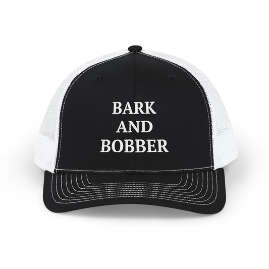 Black and white trucker hat with a snapback design, showcasing the words bark and boberr on the front.